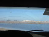The salt pile through the windshield of Mario's bus, a recycled Thrifty Car Rental airport shuttle.