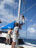 Stephen goes up the mast; Ross is hoisting as Pete belays.