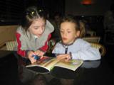 Natalie (left) reads to Caitlin
