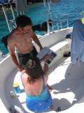 Kathy shows Pete a picture of the Spotted Drum she had just seen while snorkeling.